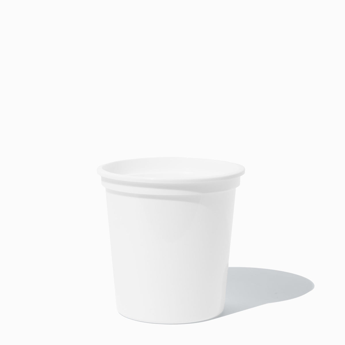 White plastic pint to-go containers stacked and ready to serve