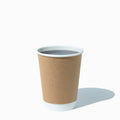 Close-up of 12 oz double-wall kraft paper hot cups stacked and ready to serve