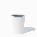 Close-up of 12 oz white paper ice cream cups stacked and ready to serve