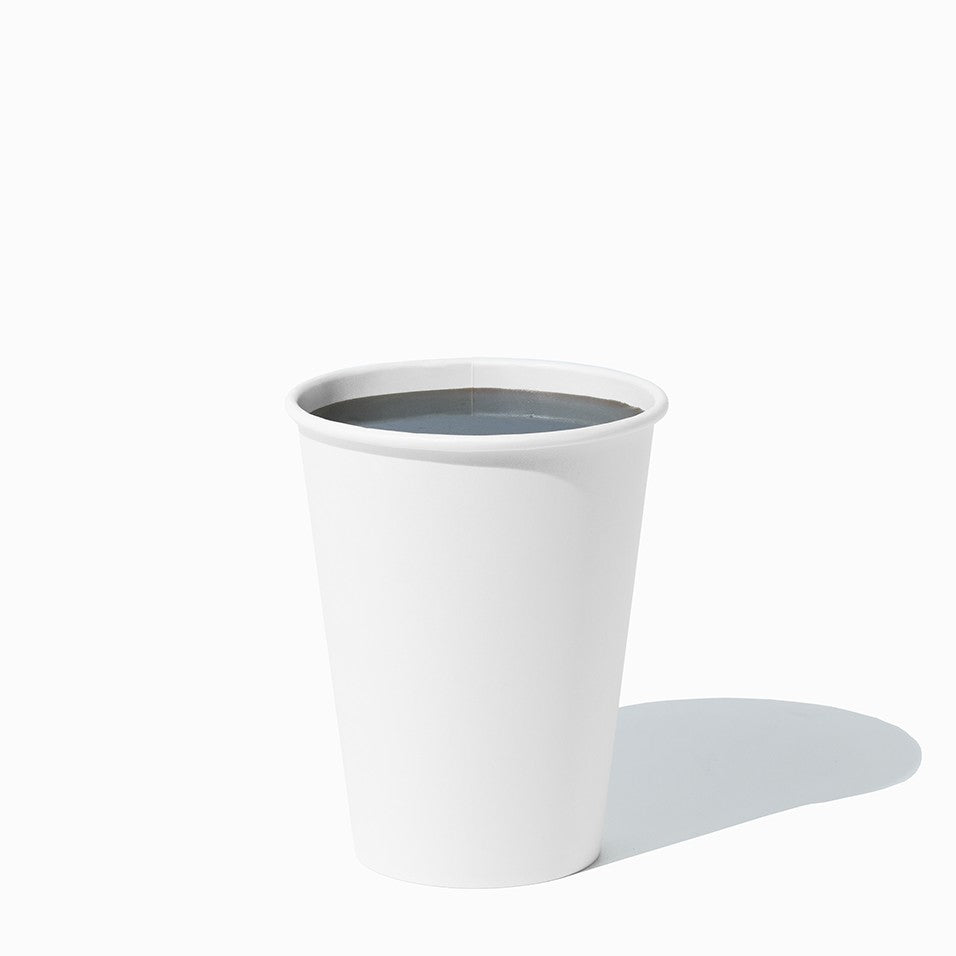Close-up of 12 oz white paper ice cream cups stacked and ready to serve