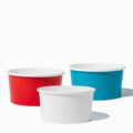 Close-up of 6 oz assorted ice cream cups stacked and ready to serve