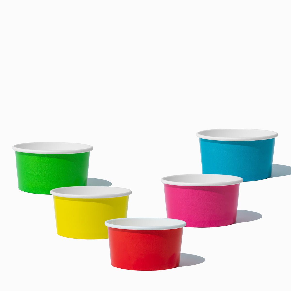 Close-up of 6 oz assorted paper ice cream cups stacked and ready to serve