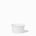 Close-up of 8 oz white compostable to-go containers stacked and ready to serve