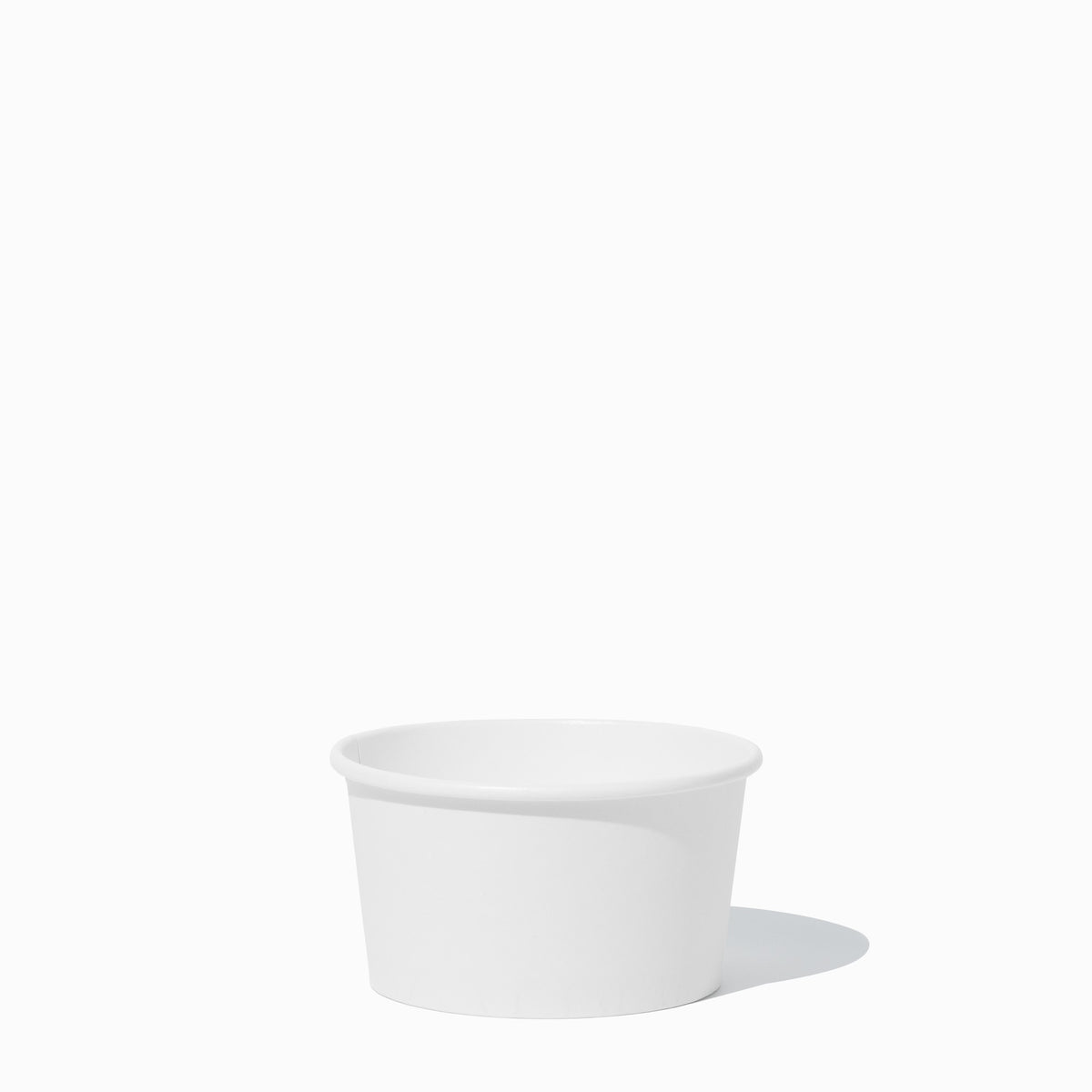 Close-up of 8 oz white compostable to-go containers stacked and ready to serve