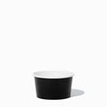 Close-up of 8 oz black paper to-go containers stacked and ready to serve