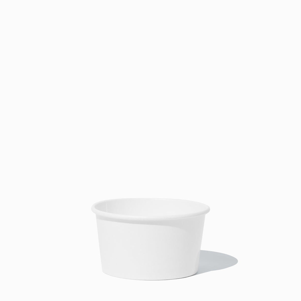 Close-up of 8 oz white paper to-go containers stacked and ready to serve