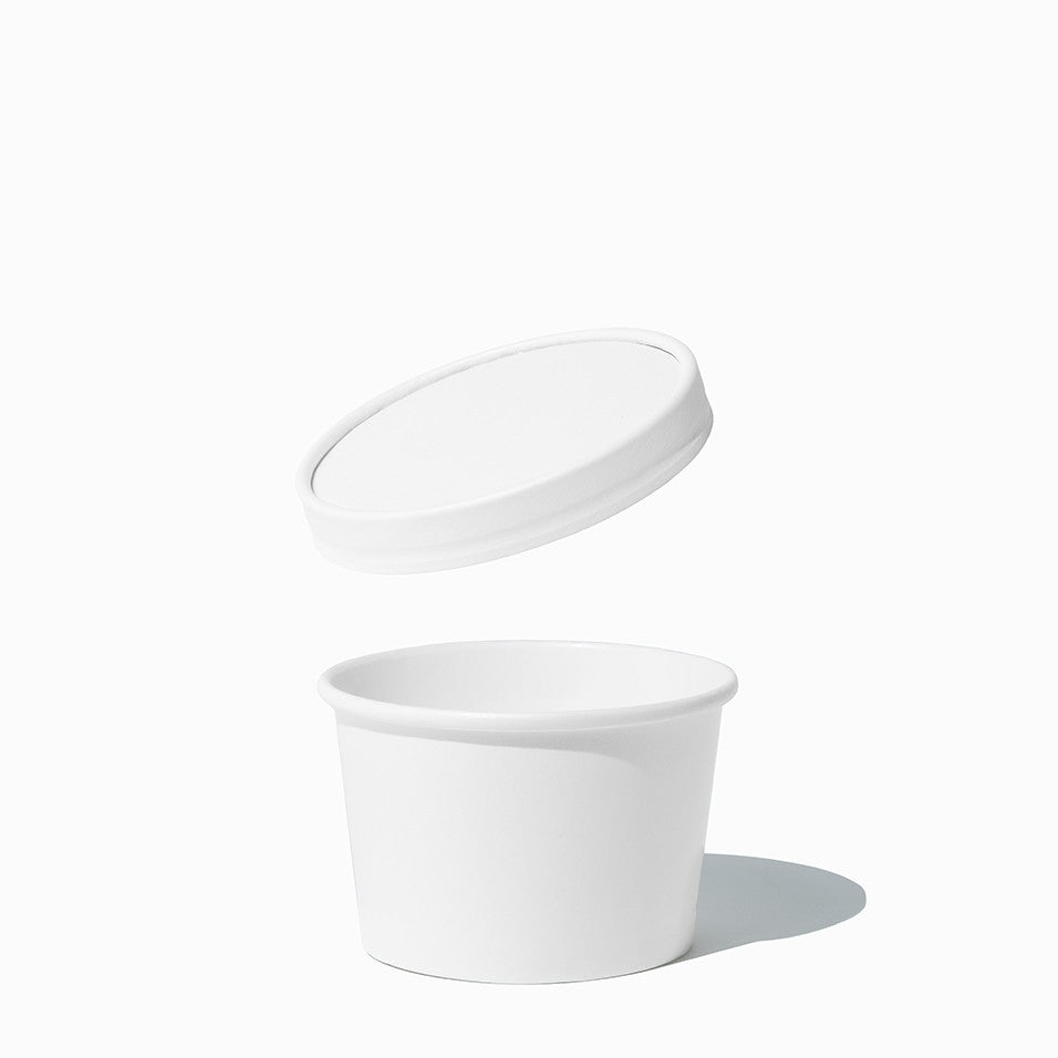 Close-up of 8 oz white cup lids stacked and ready to serve