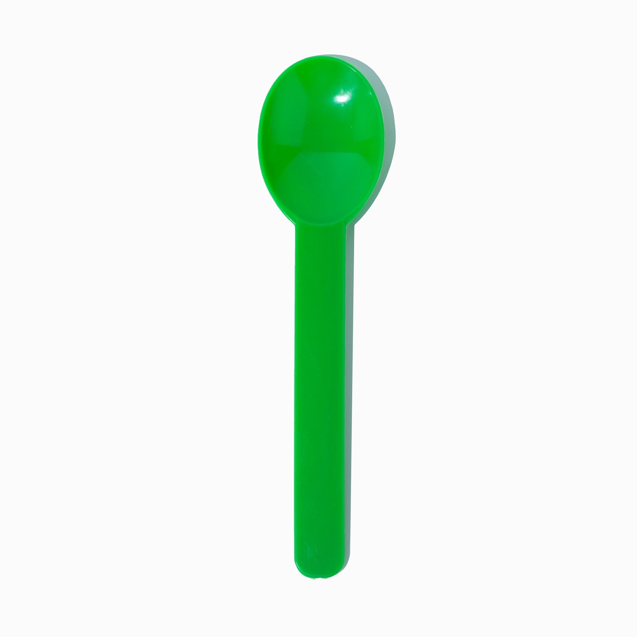 Close-up of green compostable tasting spoons stacked and ready to serve