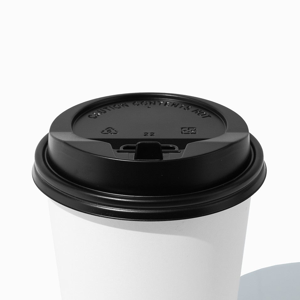 Close-up of 20 oz black paper cup lids stacked and ready to serve