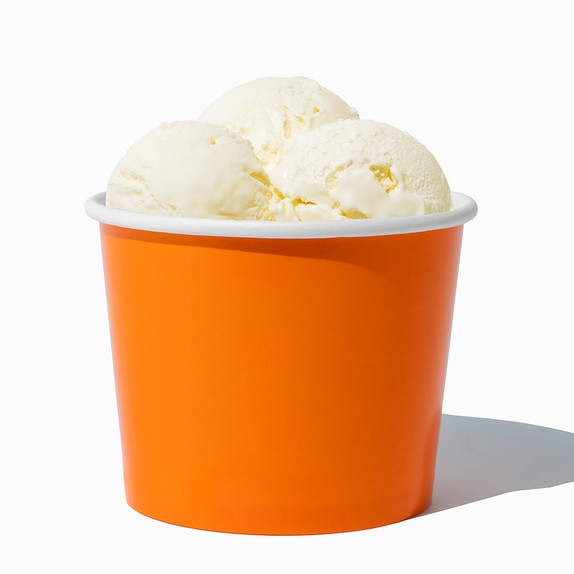 Close-up of 12 oz orange ice cream cups stacked and ready to serve