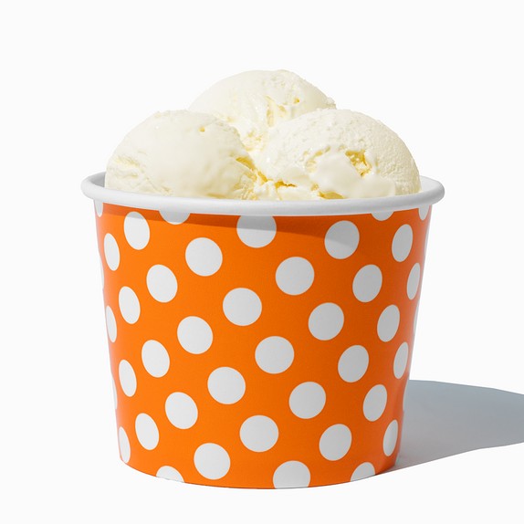 Close-up of 12 oz orange ice cream cups stacked and ready to serve
