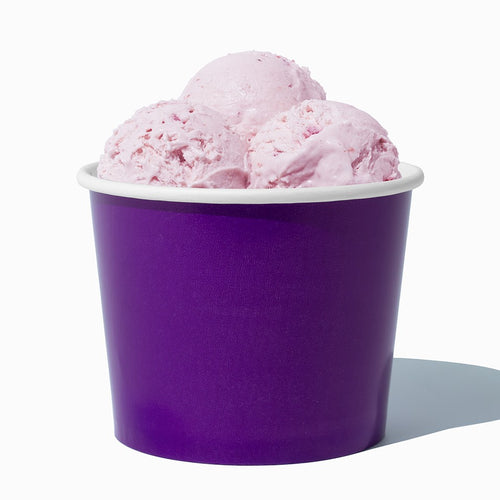 Close-up of 12 oz purple ice cream cups stacked and ready to serve