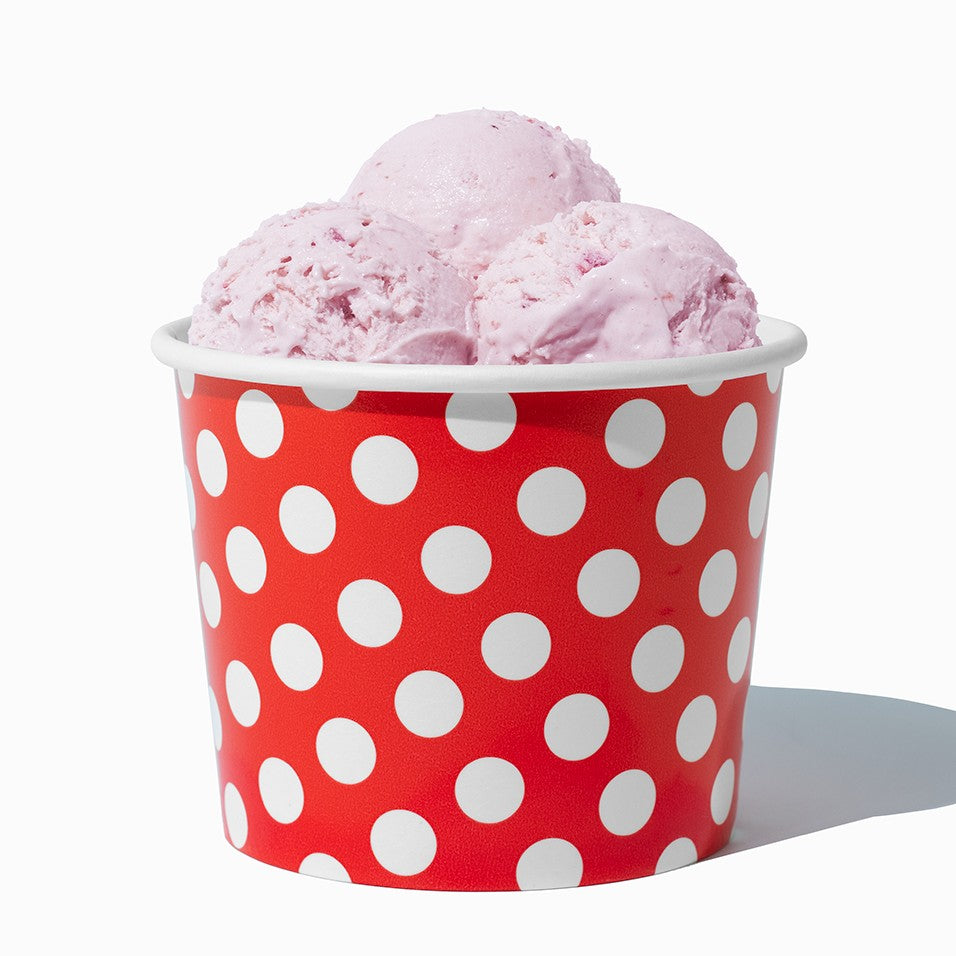 Close-up of 12 oz red ice cream cups stacked and ready to serve