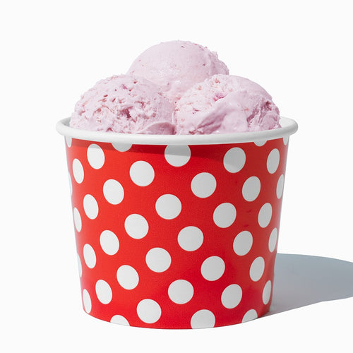 Close-up of 12 oz red ice cream cups stacked and ready to serve