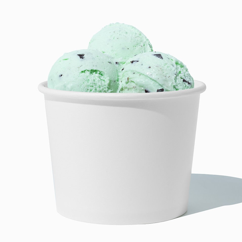 Close-up of 12 oz white paper ice cream cups stacked and ready to serve