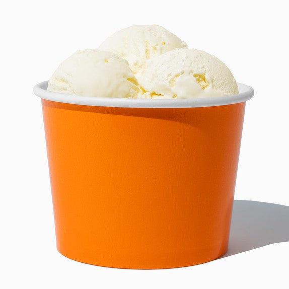 Close-up of 16 oz orange ice cream cups stacked and ready to serve