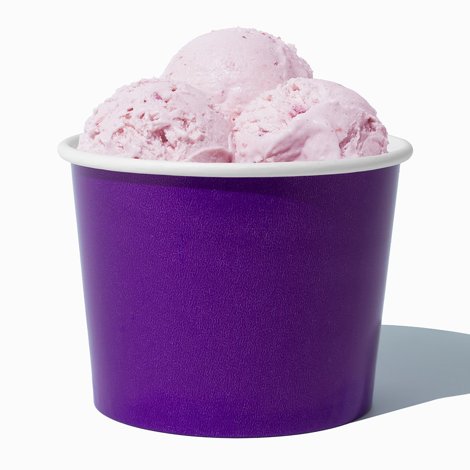 Close-up of 16 oz purple ice cream cups stacked and ready to serve