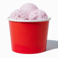 Close-up of 16 oz red ice cream cups stacked and ready to serve
