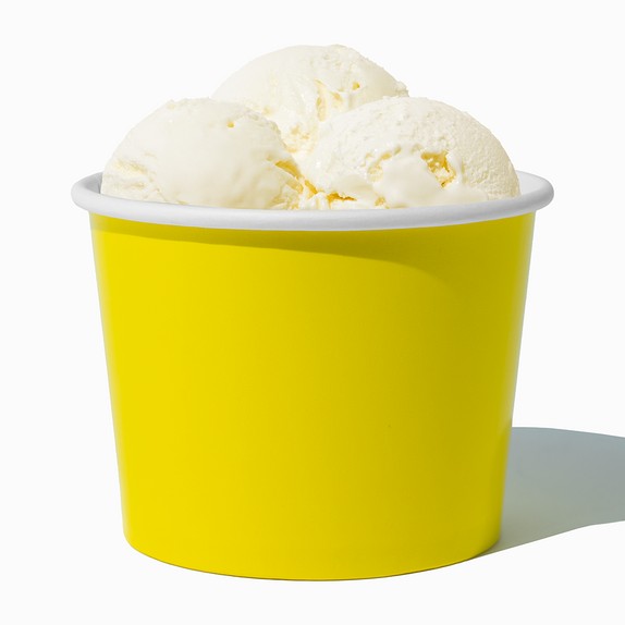 Close-up of 16 oz yellow paper ice cream cups stacked and ready to serve