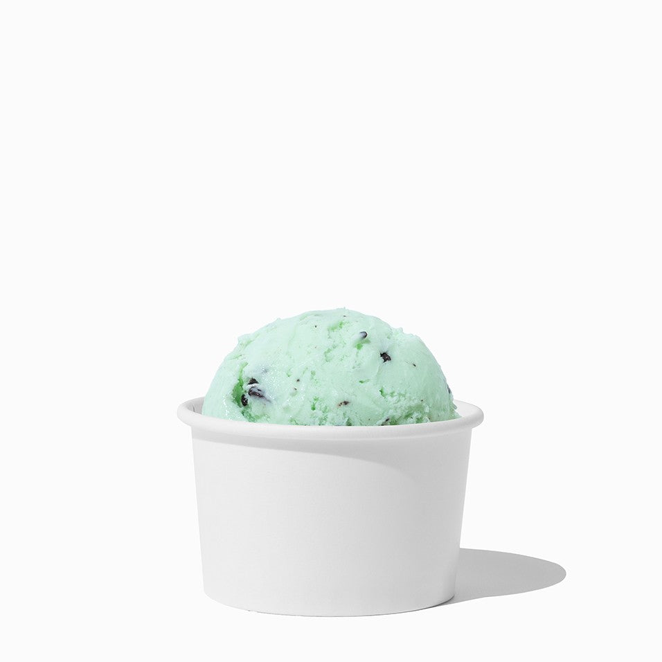 Close-up of 3 oz white paper ice cream cups stacked and ready to serve