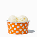 Close-up of 6 oz orange ice cream cups stacked and ready to serve