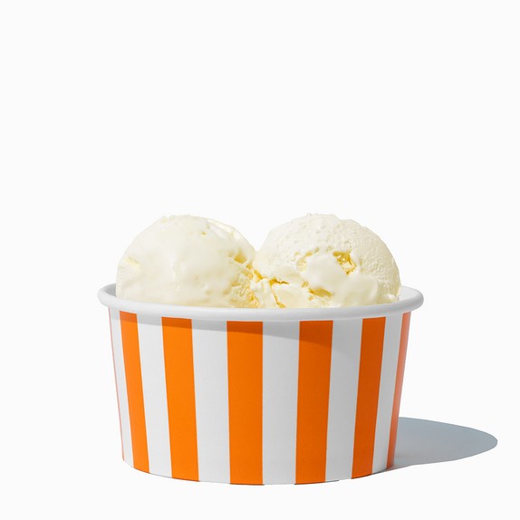 Close-up of 6 oz orange ice cream cups stacked and ready to serve