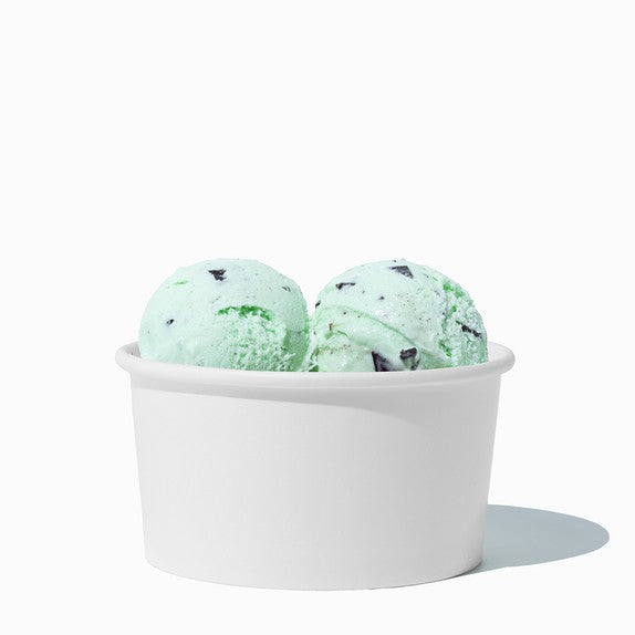 Close-up of 6 oz white paper ice cream cups stacked and ready to serve