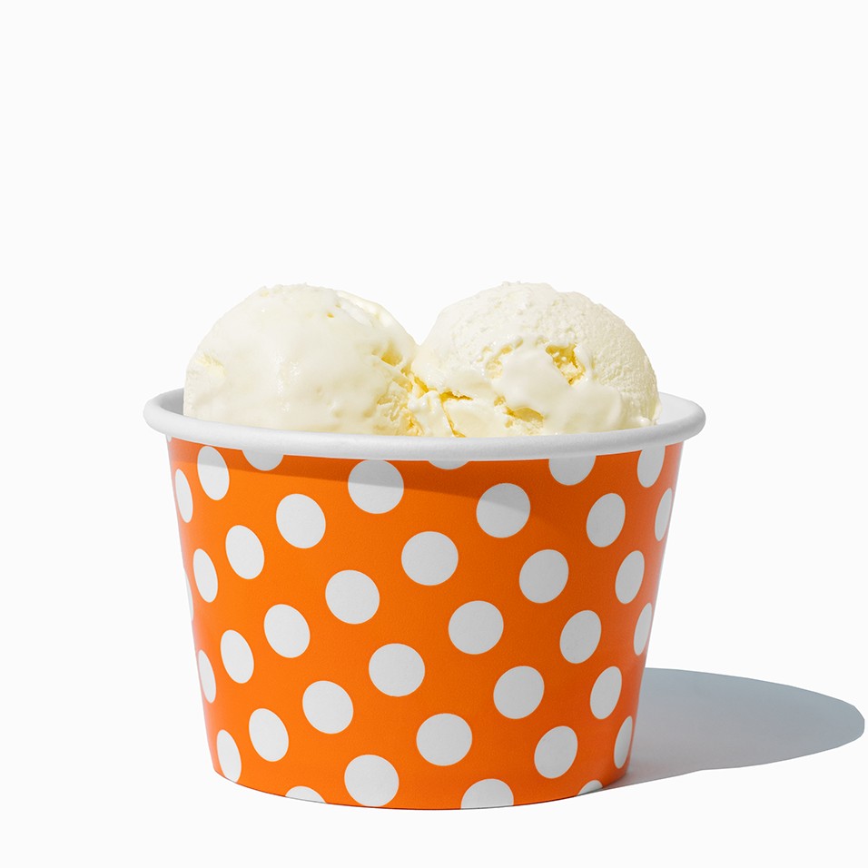Close-up of 8 oz orange ice cream cups stacked and ready to serve