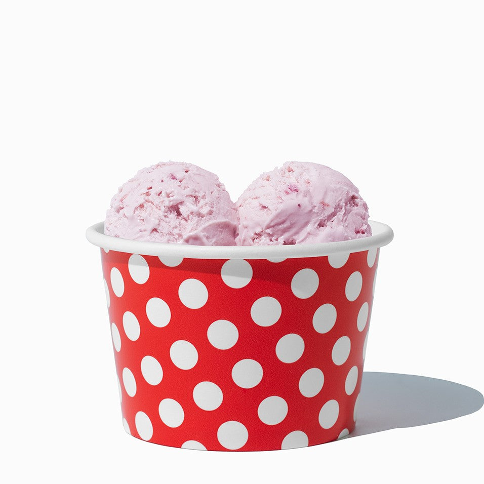 Close-up of 8 oz red ice cream cups stacked and ready to serve