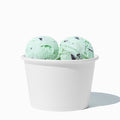 Close-up of 8 oz white ice cream cups stacked and ready to serve