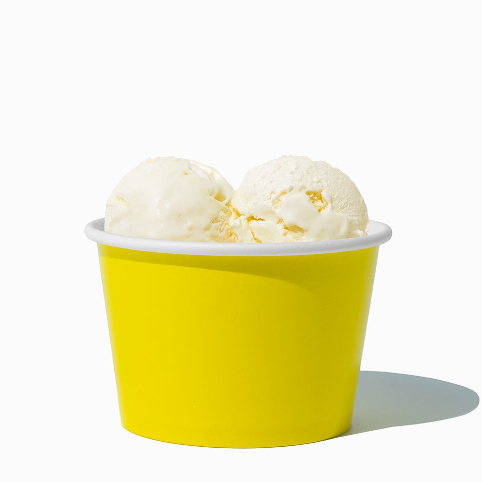 Close-up of 8 oz yellow ice cream cups stacked and ready to serve