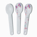 Close-up of assorted tasting spoons stacked and ready to serve