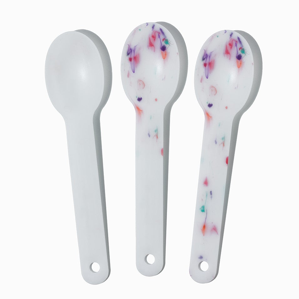 Close-up of assorted tasting spoons stacked and ready to serve