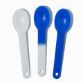 Close-up of assorted plastic tasting spoons stacked and ready to serve