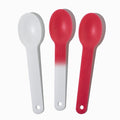 Close-up of assorted plastic tasting spoons stacked and ready to serve