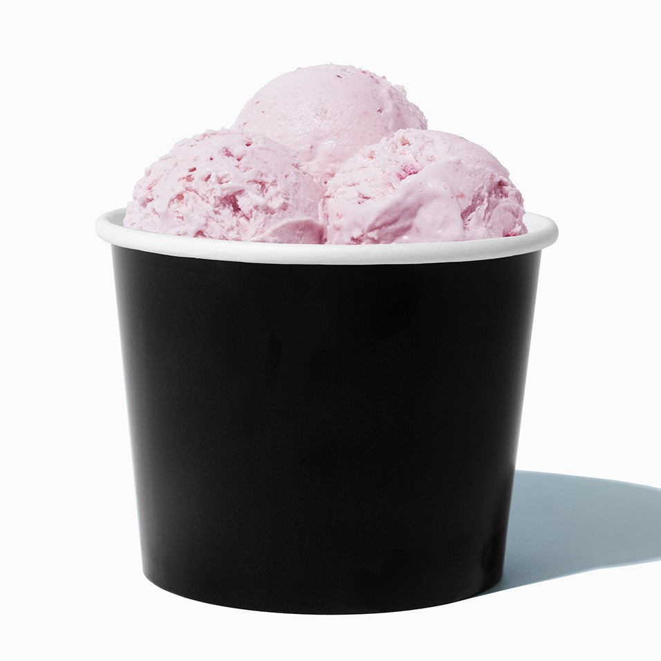 Close-up of 12 oz black ice cream cups stacked and ready to serve
