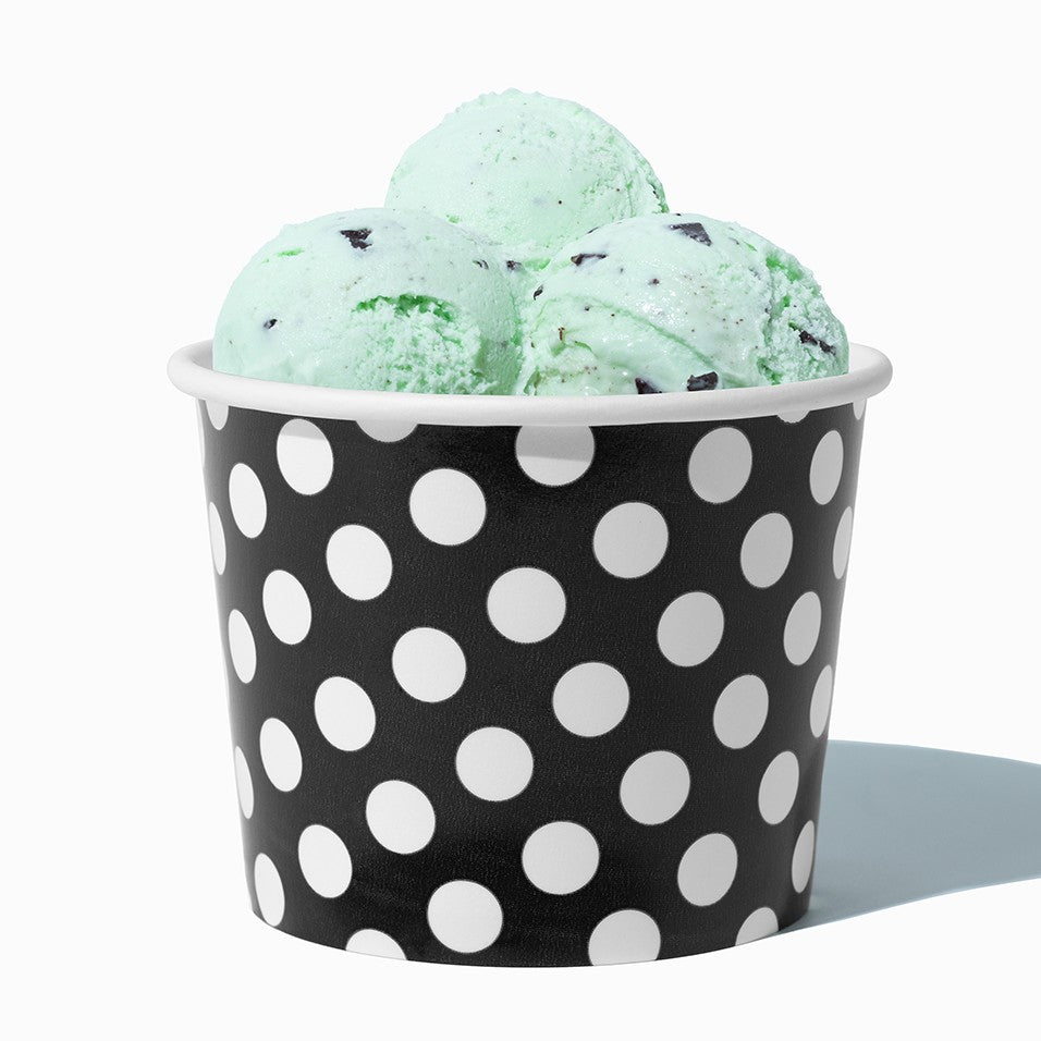 Close-up of 12 oz black ice cream cups stacked and ready to serve