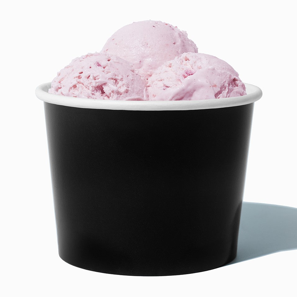 Close-up of 16 oz black paper ice cream cups stacked and ready to serve