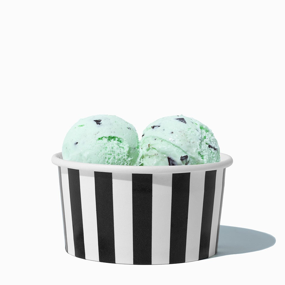 Close-up of 6 oz black ice cream cups stacked and ready to serve