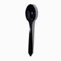 Close-up of black plastic tasting spoons stacked and ready to serve