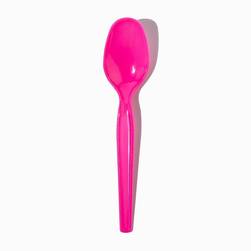 Close-up of pink plastic tasting spoons stacked and ready to serve