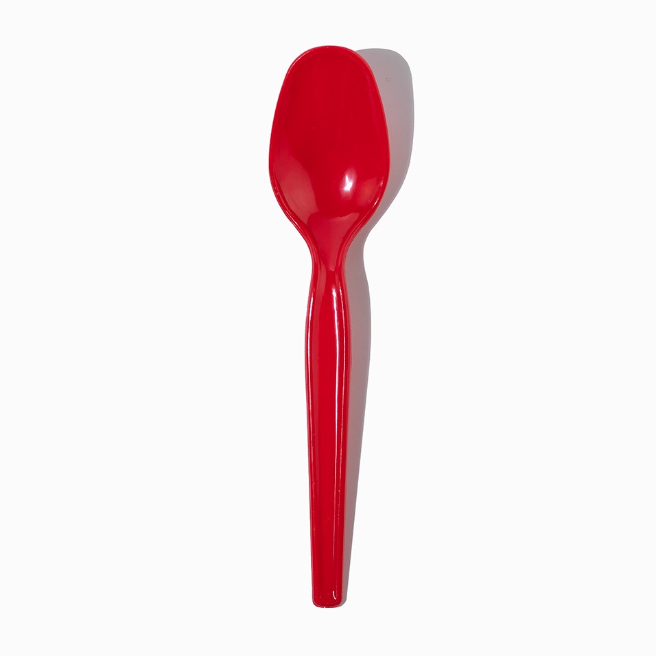 Close-up of red tasting spoons stacked and ready to serve