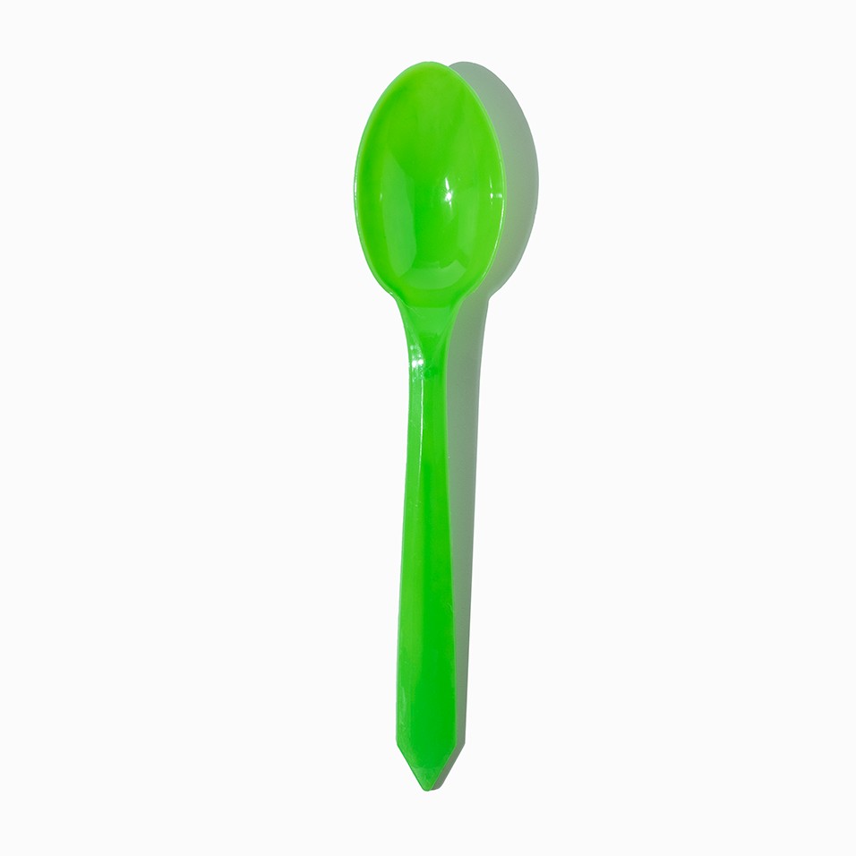 Close-up of green tasting spoons stacked and ready to serve