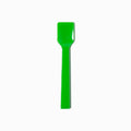 Close-up of green tasting spoons stacked and ready to serve