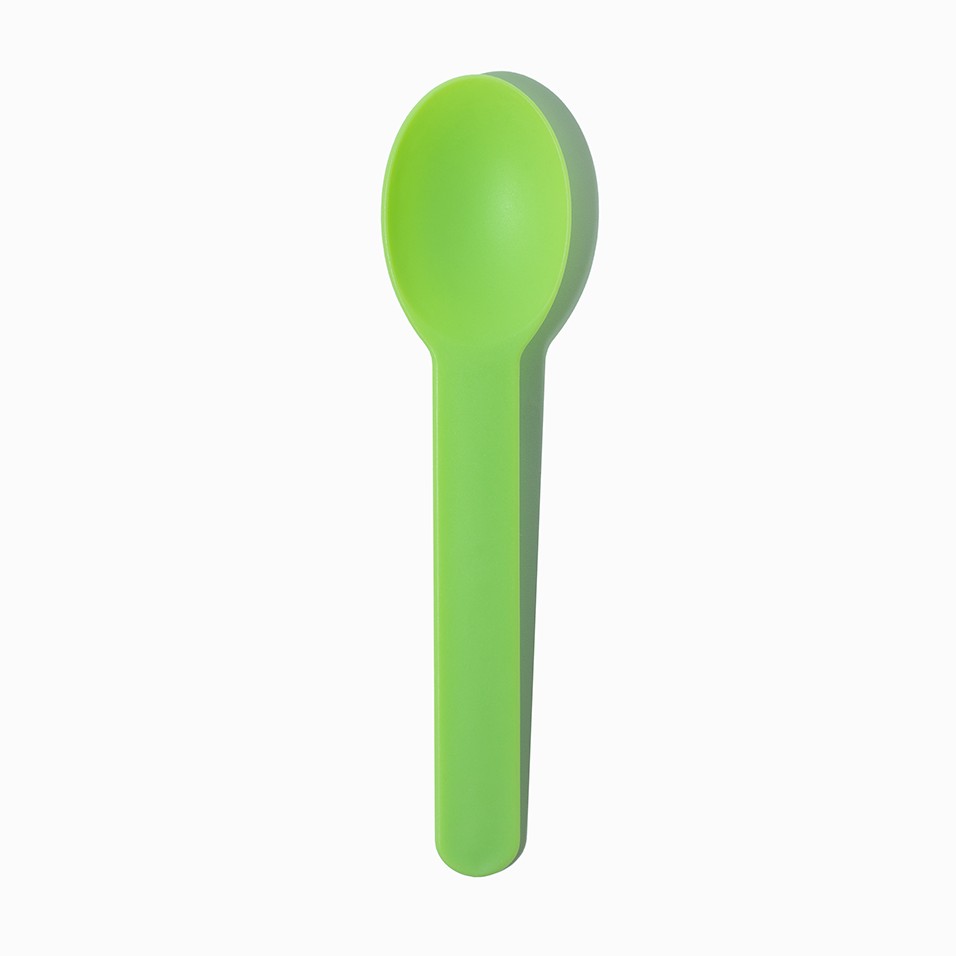 Close-up of green tasting spoons stacked and ready to serve