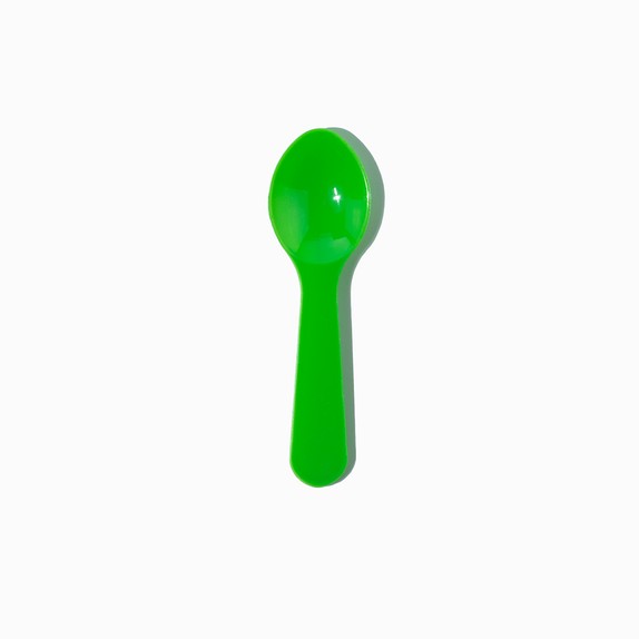 Close-up of green tasting spoons stacked and ready to serve