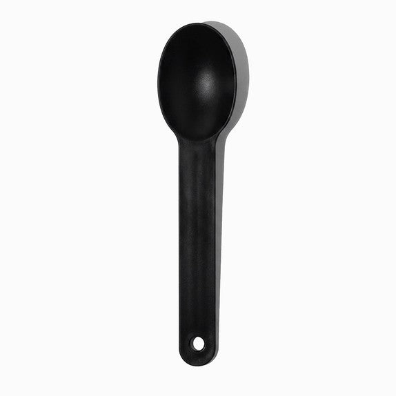 Close-up of black tasting spoons stacked and ready to serve