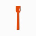Close-up of orange tasting spoons stacked and ready to serve