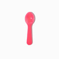 Close-up of pink tasting spoons stacked and ready to serve