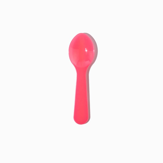 Close-up of pink tasting spoons stacked and ready to serve